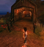 The iconic wooden bridge of Oakvale, set ablaze by bandits.