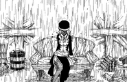 Juvia sits alone in the rain in the deserted Rainfell Town