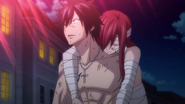 Gray carries an injured Erza out of Hargeon