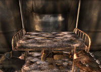 A sniper rifle lies on the center bunk in 1st Recon's tent.