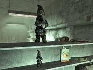 On the bottom shelf, one of the smallest damaged garden gnomes in Fallout 3.