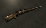 The hunting rifle with the scope and the custom bolt modification
