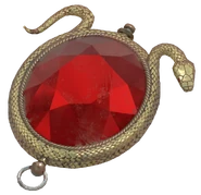 The Eye of Ra, a brooch worn by the Mistress of Mystery, modeled after the sun-disk symbol of the ancient Egyptian god Ra