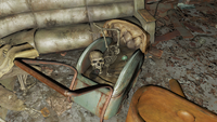 Small skeleton with a full sized skull in a crib