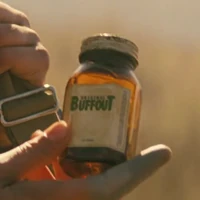 Lucy MacLean holding a glass vial of Buffout in Fallout season two