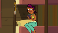 Sierra in the loser cabin with her phone.