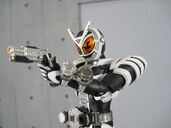 Kamen Rider Delta X is holding her Delta Blaster X