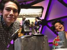 A behind-the-scenes photo of  and  posing with their minis before filming, taken by Zac and shared on the Dropout Discord July 31, 2019.