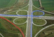 The km 10 (mi 5) of Highway in Karlmaxine Interchange, Karlmaxine, Chickenland. In blue is the way towards the highway and in red is the way back from the road