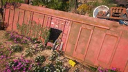 The toppled freight car contains a small stash of items behind breakable wooden planks