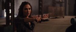 Gisele aiming her pistol at Roman Pearce