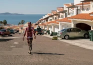 Nick walking through an abandoned neighbourhood to meed Luis Flores