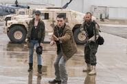 Known members, standing in front of a military Humvee