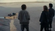 They look at Calvin's body where it's landed at the bottom of the ramp.
