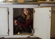 Alicia, hiding so that Jack can't find her