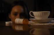 Alicia examins the pill bottle Susan Tran used to commit suicide