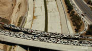 An aerial shot shows us roads completely blocked with cars