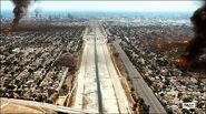 Smoke drifts over the LA river as the city burns