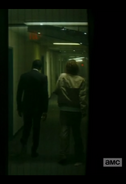 Strand and Nick make their way along a corridor