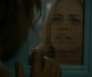 Madison looks through a window on a locked door in the facility