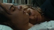 Nick and his mother, asleep on his bed at the hospital.