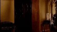 Foster Prentiss sits at the table and winks at Violet