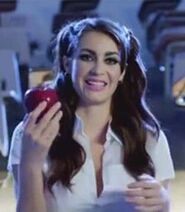 Lilith in a school uniform with an apple in her hand