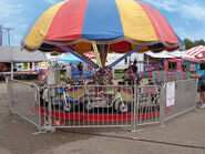 Motorcycles kiddie umbrella ride (with hill for "jumps")