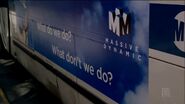 Massive Dynamic ad on the side of a bus in "The Road Not Taken".