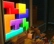 Asterix about to blow up a Tetramino wall using a Bomberman bomb.