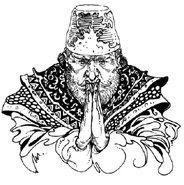 Khasim with his hands clasped together.