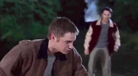 Carter standing in the foreground, having urinated himself from his near-death experience, as Alex figures out Death's design.