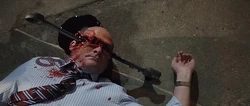 A wrench is forced into Dennis' head, killing him.