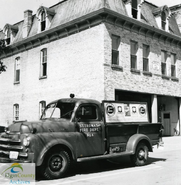Dodge truck in front of the Southwick Street Fire Hall, ca. 1965. Exhibit mounted in the truck bed indicates the vehicle was used by the Fire Prevention officer in conducting the Department's public education and outreach activities. Courtesy Elgin County Archives, part of the Dave Rock Collection