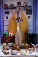 The real-life forged rendition of the Falchion, photographed amidst other Fire Emblem-related paraphernalia during a Nintendo World launch event.