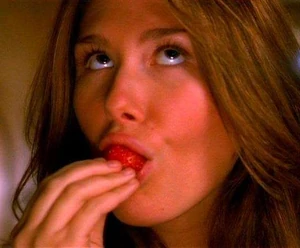 Kaylee consumes one of Shepherd Book's strawberries.