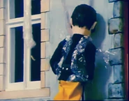 Elvis unsuccessfully trying to stop water from shooting out of the broken tap