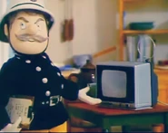 Station Officer Steele standing beside the station's TV
