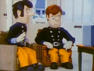 Sam and Elvis watching Station Officer Steele on the portable TV
