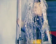 Elvis being sprayed by the broken tap, note that the water is cling film