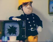 Sam standing beside the broken TV