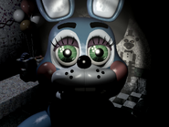 Toy Bonnie staring into the camera with the flashlight on