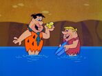 Fred and Barney with real shiny gold rocks in the episode, "The Treasure of Sierra Madrock".