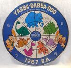 A 1967 Busch Beer dartboard with Fred, Barney and Dino with a Stegosaurus, a Brontosaurus, a Saber-Toothed Cat, a Lizardsaurus, a Mammoth and a Triceratops.