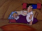 Fred and Barney sleeping on a couch at night in the episode, "The House Guest".