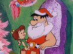 Fred as a mall Santa and a little girl in the episode, "Christmas Flintstone".