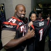  presents a Renegades jersey to U.S. Secretary of State  at the  in 2005.