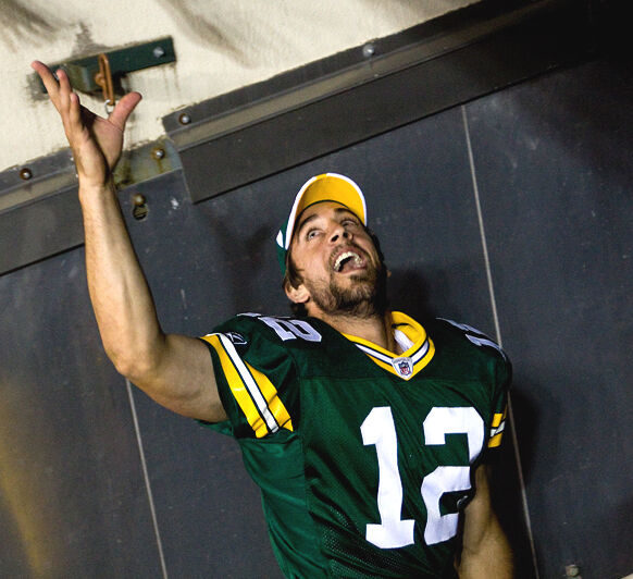 30 November 2008: Green Bay Packers quarterback Aaron Rodgers (12) hands  off the football in the first quarter at Lambeau Field in Green Bay,  Wisconsin. The Panthers defeated the Packers 35-31. (Icon