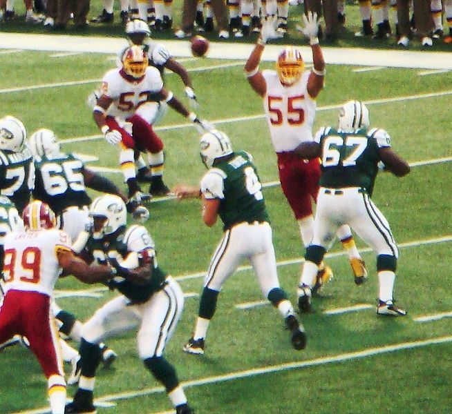 Miami Dolphins quarterback Dan Marino is sacked by New York Jets defensive  end Marvin Washington for a two yard loss in the second quarter of NFL play  in East Rutherford, New Jersey, Sunday, Sept. 29, 1991. Jets Dennis Byrd is  at left. (AP Photo/Mark