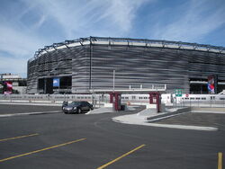The exterior of an American football stadium, which is silver.